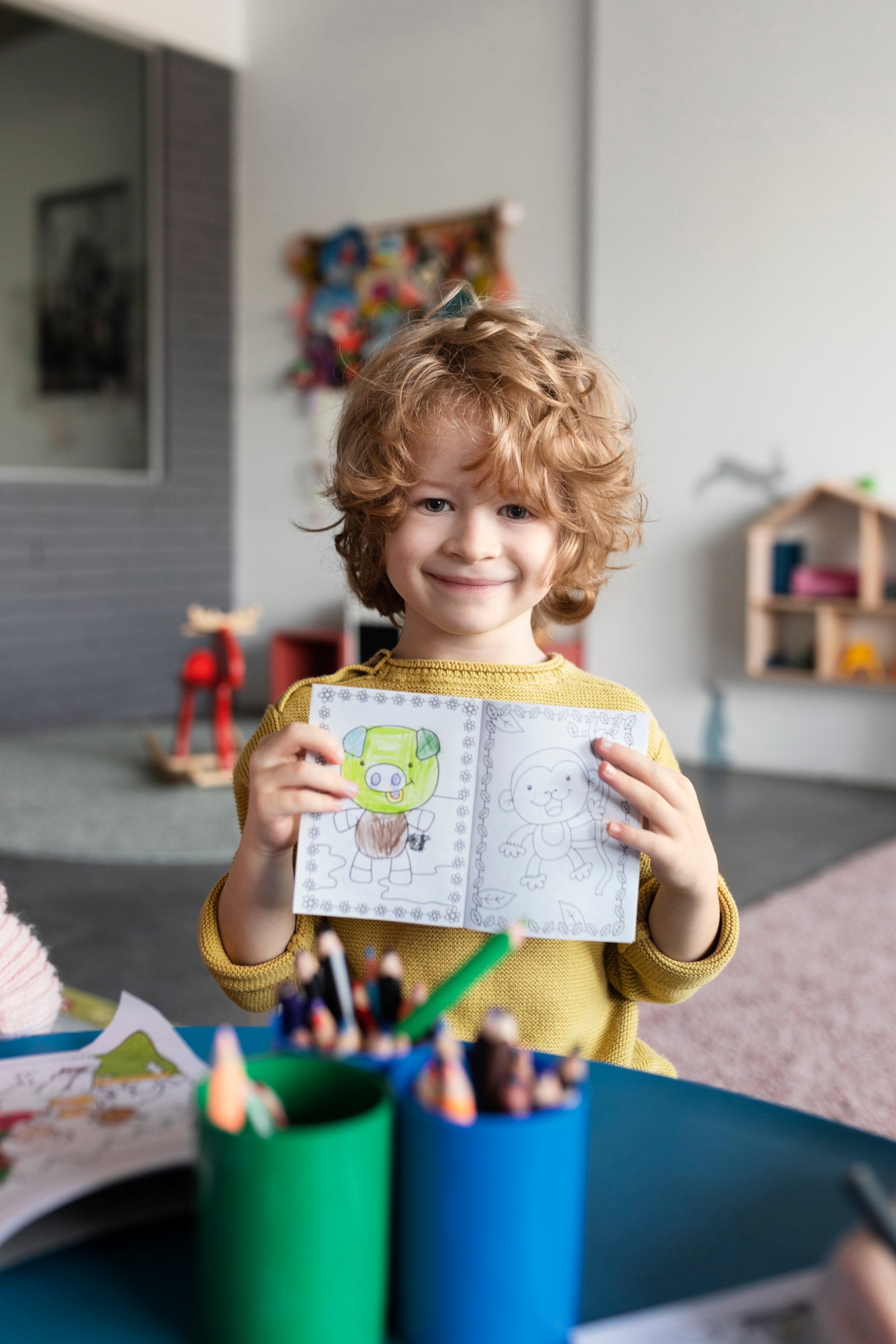 Maplewood child holding a coloring book